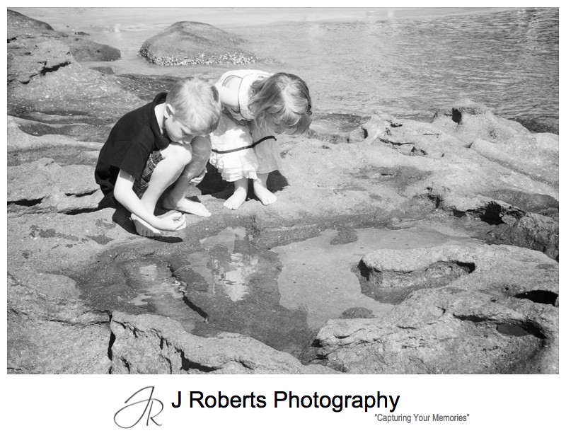 Brother and sister playing in the rockpools - family portrait photography sydney